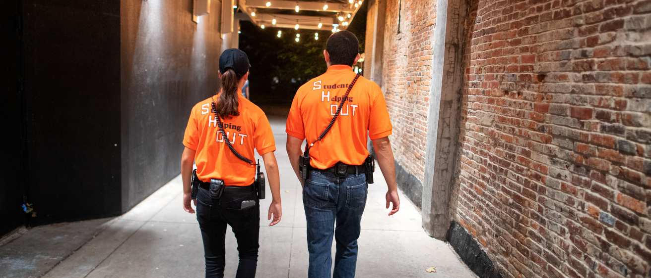 Two SHOUT student security officers walk through downtown Iowa City.