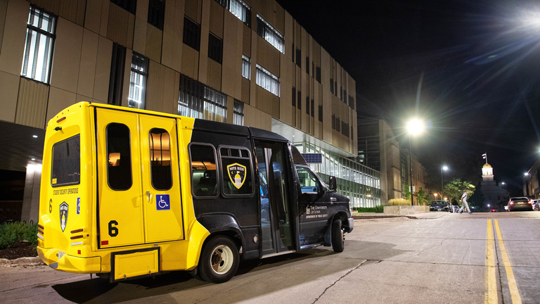 NITE RIDE shuttle drives down Madison Street at night.